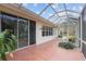 A covered patio with a concrete floor featuring sliding glass doors into the house and view of the lawn at 8223 Sw 113Th Ln, Ocala, FL 34481