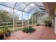 Interior of the covered patio on a sunny day, facing the manicured lawn at 8223 Sw 113Th Ln, Ocala, FL 34481