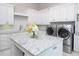 This clean, well-lit laundry room offers plenty of cabinet space and state-of-the-art appliances at 8482 Nw 31St Lane Rd, Ocala, FL 34482