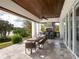 A covered outdoor dining area features a long wooden table and a grill at 8482 Nw 31St Lane Rd, Ocala, FL 34482