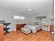 Cozy bedroom with wood floors, ceiling fan, and natural light from the windows at 8645 Sw 94Th Ln # A, Ocala, FL 34481