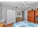 Bedroom with a ceiling fan, wood floors, and closet access at 8645 Sw 94Th Ln # A, Ocala, FL 34481