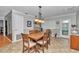 Dining room with a large wooden table, chairs, and a pendant light fixture at 8645 Sw 94Th Ln # A, Ocala, FL 34481