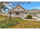 Charming home featuring a covered porch with decorative accents and a well-maintained landscaped yard at 8645 Sw 94Th Ln # A, Ocala, FL 34481