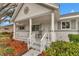 Covered front porch with white railing, ideal for relaxation at 8645 Sw 94Th Ln # A, Ocala, FL 34481