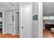 Bright hallway features wood floors, linen closet, and access to other rooms at 8645 Sw 94Th Ln # A, Ocala, FL 34481