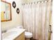 Bright bathroom with a vanity, toilet, and shower with a decorative shower curtain at 8685 Sw 94Th Ln # B, Ocala, FL 34481