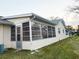 Rear exterior view of home with a screened-in patio area, offering outdoor living space at 8685 Sw 94Th Ln # B, Ocala, FL 34481