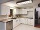 Well-lit kitchen featuring white cabinets, modern appliances, and neutral countertops at 8685 Sw 94Th Ln # B, Ocala, FL 34481