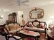 Ornate living room with classic furniture, decorative mirror, and ceiling fan at 8685 Sw 94Th Ln # B, Ocala, FL 34481