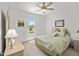 Cozy bedroom with a large window providing natural light, complemented by neutral decor at 8779 Sw 83Rd Cir, Ocala, FL 34481