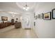 Bright foyer featuring tile floors, an oval-windowed front door, and art decorations on the white walls at 8779 Sw 83Rd Cir, Ocala, FL 34481