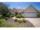 Inviting single-story home displaying well-maintained landscaping, neutral paint, and a convenient two-car garage under blue skies at 8779 Sw 83Rd Cir, Ocala, FL 34481