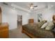 Main bedroom featuring tray ceiling and a peek into the dining room through the doorway at 8779 Sw 83Rd Cir, Ocala, FL 34481