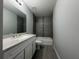 Bathroom featuring a shower and tub combination, granite countertop vanity and modern fixtures at 92 Locust Loop, Ocala, FL 34472