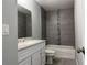 Bathroom featuring a vanity with gray countertops, a tub and a shower with tiled walls at 92 Locust Loop, Ocala, FL 34472