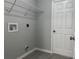 Laundry room with installed wire shelving, gray tiled floors, and a utility hookup box at 92 Locust Loop, Ocala, FL 34472