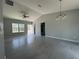 A spacious living area with high ceilings, a ceiling fan, and large windows for natural light at 92 Locust Loop, Ocala, FL 34472