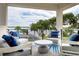 Inviting balcony with comfortable seating, offering scenic views of the water and tropical trees at 0000 Se 47Th Loop, Ocala, FL 34480