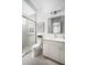 Bright bathroom with glass-enclosed shower, white vanity, and neutral-toned tiling at 0000 Se 47Th Loop, Ocala, FL 34480