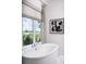 Luxurious soaking tub positioned near a window with scenic waterfront views at 0000 Se 47Th Loop, Ocala, FL 34480