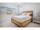 Cozy bedroom featuring a rattan bed frame and colorful beach-themed artwork at 0000 Se 47Th Loop, Ocala, FL 34480