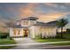 Stunning two-story home featuring a paver driveway, well-manicured lawn, and lush landscaping at 0000 Se 47Th Loop, Ocala, FL 34480