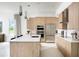 Modern kitchen featuring an island, stainless steel appliances, and wood cabinetry at 0000 Se 47Th Loop, Ocala, FL 34480