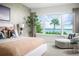 Bright main bedroom showcases water views from the large window and a comfy sitting area at 0000 Se 47Th Loop, Ocala, FL 34480