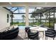 Screened-in patio features a stylish seating area and views of the pool and waterfront at 0000 Se 47Th Loop, Ocala, FL 34480