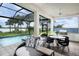 Beautiful outdoor living space with a screened-in pool, waterfront views, and seating at 0000 Se 47Th Loop, Ocala, FL 34480