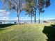 Lush backyard with picnic seating under mature trees, providing serene water views and a tranquil atmosphere at 11001 Se Sunset Harbor Rd # A08, Summerfield, FL 34491
