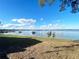 Backyard featuring a view of the lake with docks, boats, and a blue sky at 11001 Se Sunset Harbor Rd # A08, Summerfield, FL 34491
