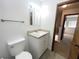 A clean bathroom with light grey tile flooring, a large mirror, and white vanity at 11001 Se Sunset Harbor Rd # A08, Summerfield, FL 34491