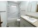 A clean bathroom with a white tub/shower combo, light grey tile flooring, and vanity sink at 11001 Se Sunset Harbor Rd # A08, Summerfield, FL 34491