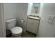 Bathroom featuring toilet and vanity with light grey tile flooring at 11001 Se Sunset Harbor Rd # A08, Summerfield, FL 34491