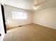 Cozy bedroom featuring neutral carpeting, a ceiling fan, and ample natural light at 11001 Se Sunset Harbor Rd # A08, Summerfield, FL 34491