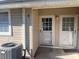 Close-up of a condo entrance featuring a well-kept patio, white doors, and easy access at 11001 Se Sunset Harbor Rd # A08, Summerfield, FL 34491