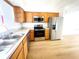 Functional kitchen with stainless steel appliances, oak cabinets, and durable countertops at 11001 Se Sunset Harbor Rd # A08, Summerfield, FL 34491