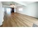 Spacious living room featuring wood-look floors, a ceiling fan, and seamless open-concept design at 11001 Se Sunset Harbor Rd # A08, Summerfield, FL 34491