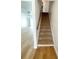 Staircase leading to the upper level, enhanced by modern flooring and natural light at 11001 Se Sunset Harbor Rd # A08, Summerfield, FL 34491