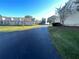 Community street view with condo exteriors and landscaping on a clear day at 11001 Se Sunset Harbor Rd # A08, Summerfield, FL 34491