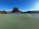Tennis courts featuring blue and green surface in a well-maintained community at 11001 Se Sunset Harbor Rd # A08, Summerfield, FL 34491