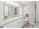 Updated bathroom featuring modern fixtures, a large mirror, and a granite countertop sink at 11204 Sw 63Rd Terrace Rd, Ocala, FL 34476