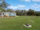 Charming single-story home with a large yard surrounded by lush trees at 11745 Nw 15Th Lane, Ocala, FL 34482