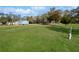 A beautiful single-story home sits on a vast, green lawn surrounded by trees at 11745 Nw 15Th Lane, Ocala, FL 34482