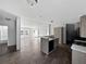 Updated kitchen featuring light wood floors, an island, and neutral walls at 11745 Nw 15Th Lane, Ocala, FL 34482