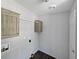 A functional laundry room featuring hanging cabinets and wood-look floors at 11745 Nw 15Th Lane, Ocala, FL 34482