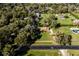 Wide aerial view of a rural property featuring a charming home with a red roof amid lush greenery at 1255 Ne 70Th St, Ocala, FL 34479