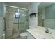 Bathroom features a glass shower with a seat, safety bar, standard toilet, and a vanity with sink at 1255 Ne 70Th St, Ocala, FL 34479